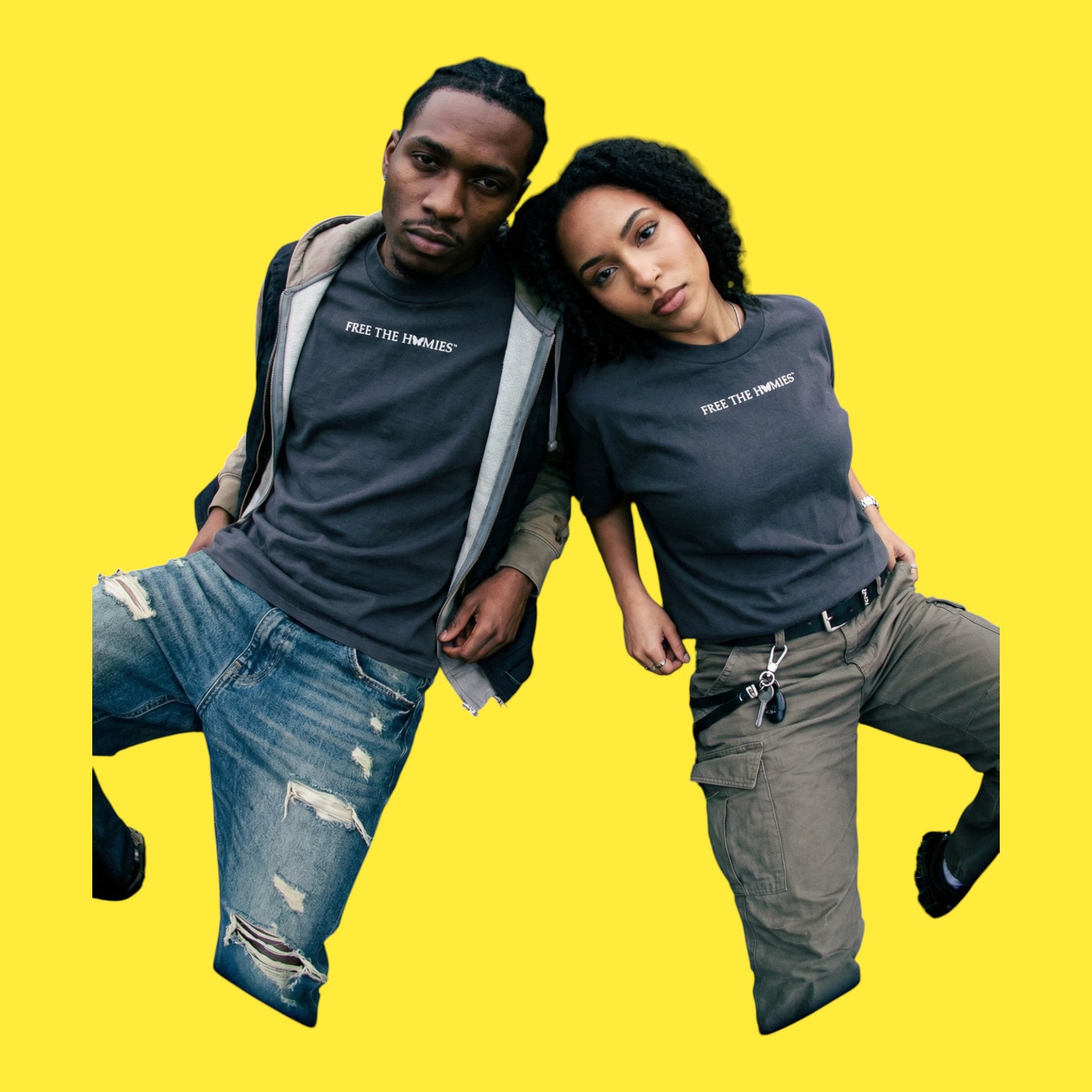 2 models wearing Blackout T-shirt with Free The Homies text on a yellow background