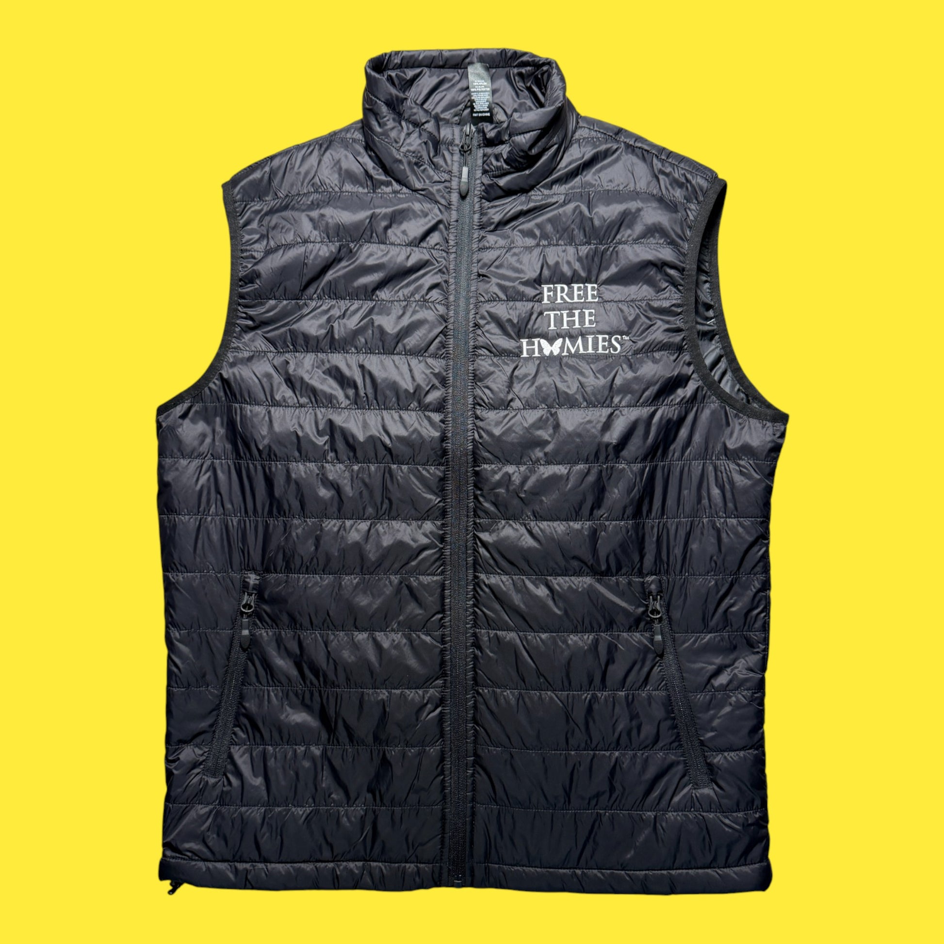 Black puffer vest with text on a yellow background