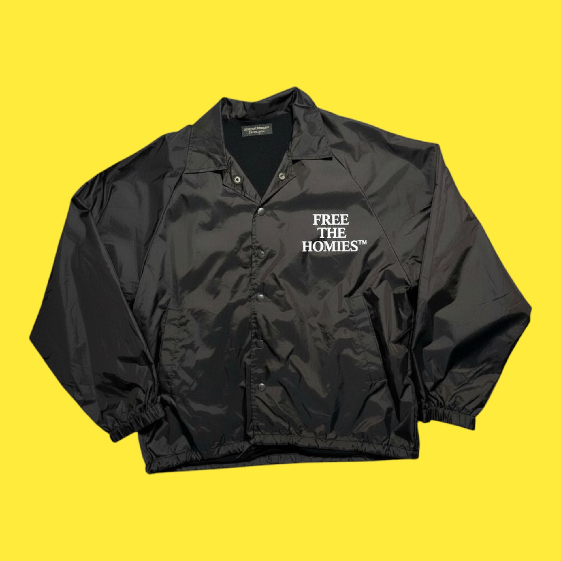 Black jacket with 'FREE THE HOMIES' text on a yellow background