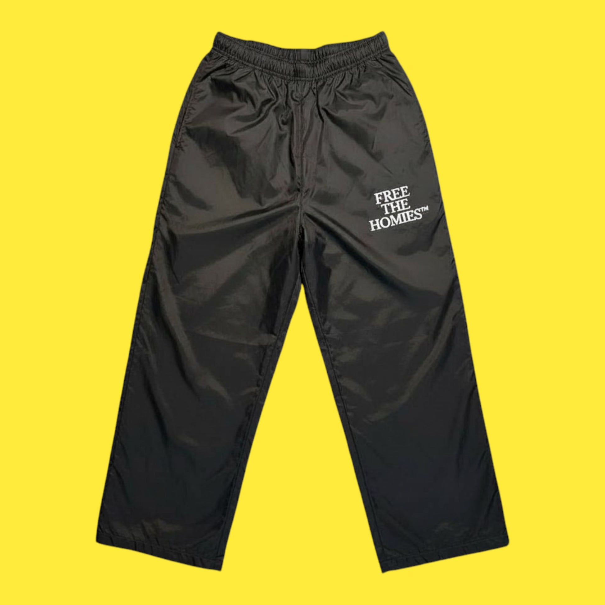Black pants with 'Free the Homies' text on a yellow background